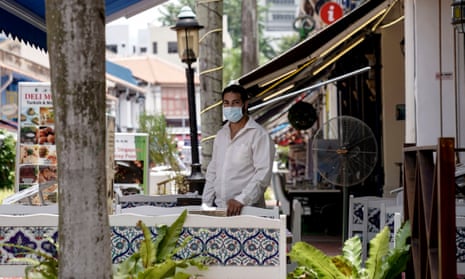 A man stands in the al fresco dining area of his restaurant situated in the Kampong Glam cultural district of Singapore.