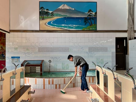 Koichi Matsumoto scrubs the floor of his bathhouse in north-east Tokyo.