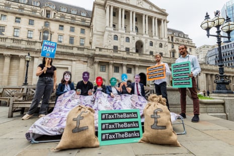 Positive Money stunt, London, United KingdomLondon, UK. 07 AUG, 2025. Campaigners from various groups including non-profit, Positive Money and Tax Justice UK, staged a humorous stunt outside the Bank of England. Urging the government to "get out of bed" with the banks, they called for banks to be taxed more, ahead of todays Bank of England rate decision. Credit Milo Chandler/Alamy Live News