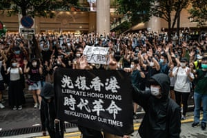 Protesters hold up signs