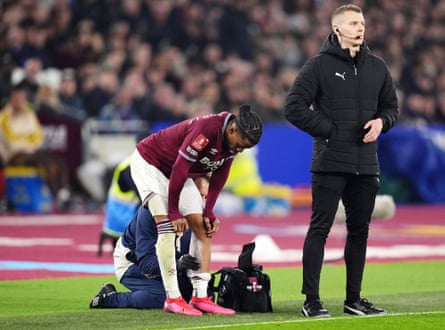 Crysencio Summerville receives treatment on his leg leg on the side of the pitch during West Ham's FA Cup tie against Brentford