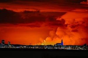 Reykjavik’s skyline is illuminated by light from molten lava