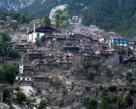 Dozens of homes of varying sizes cling precariously to a mountainside