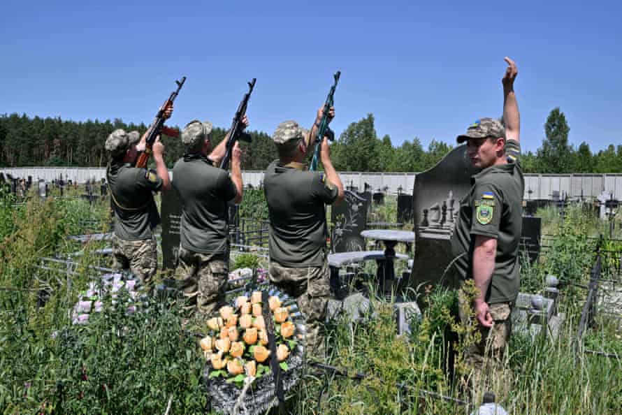 Servicemen fire a salvo in tribute to Ukrainian servicemen Vladislav Andreev killed in Donetsk region, during his funeral ceremony at Bucha’s cemetery.
