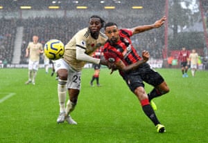 Bournemouth’s Callum Wilson tussle at a wet Vitality Stadium.