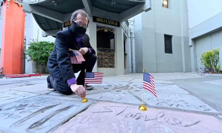 Levi Tinker of the TCL Chinese Theater places hand flags and star prints on Veterans Day.