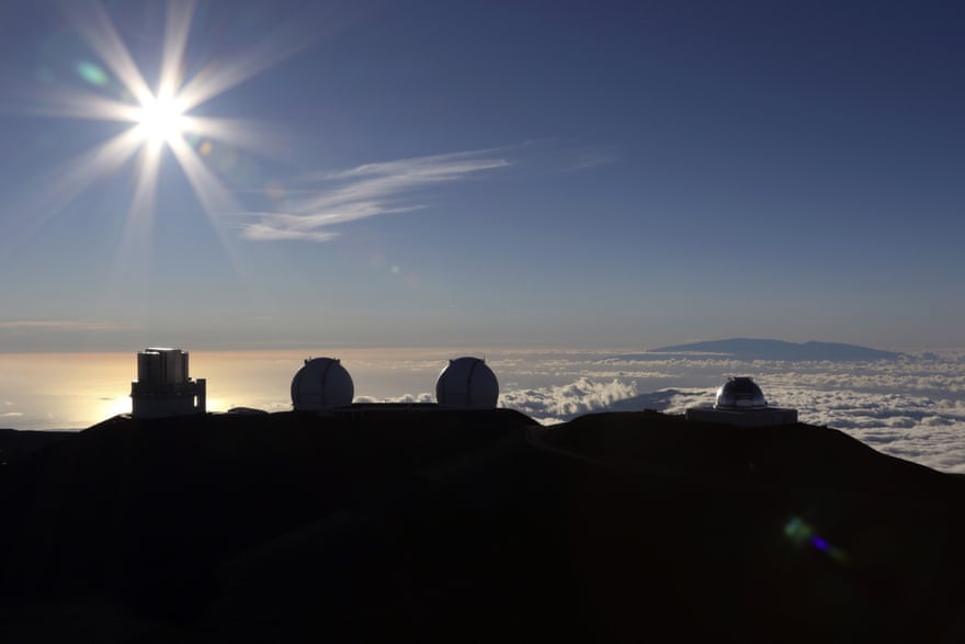 The sun sets behind telescopes at the summit of Mauna Kea in Hawaii.