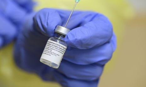 A staff member holds an injection vial with the coronavirus vaccine at the municipal hospital in Dresden, Germany.