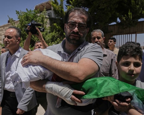 Fahd Abu Haikal carries the body of his seven month old Palestinian baby boy Sam