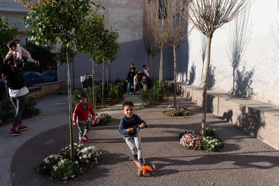 Children play in a pocket park in Kolonos in Athens