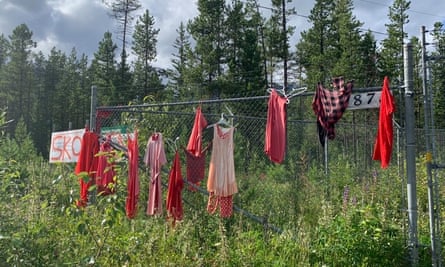 Red dresses hang on a fence near the TransMountain pipeline site in Blue River, British Columbia. Red dresses symbolize murdered and missing Indigenous women and girls.