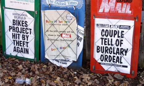 A row of local newspaper display boards