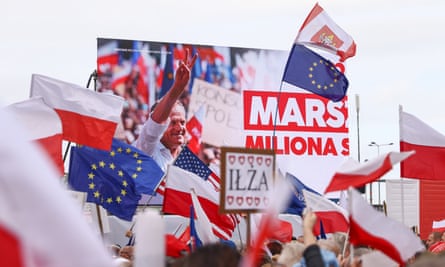 A picture of Donald Tusk is screened during an opposition march in Warsaw.