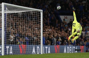 Thibaut Courtois dives but can’t stop Henderson’s dipping strike.