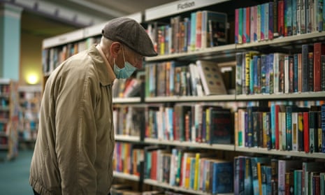 Man looking at books in a library