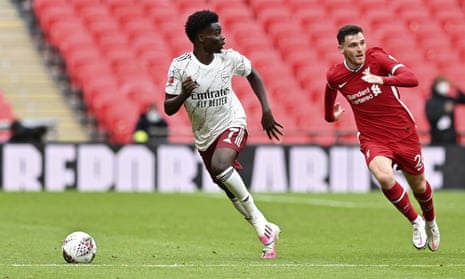 Bukayo Saka bursts away from Liverpool’s Andrew Robertson during the Community Shield at Wembley on Saturday.