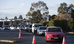 A long line of cars are parked waiting for Covid-19 testing