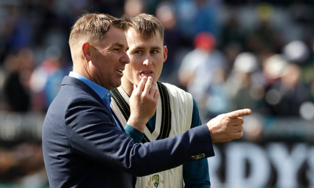Shane Warne, pictured with Marnus Labuschagne, has called on cricket to do more to address the threats to the sport posed by flooding and rising temperatures.