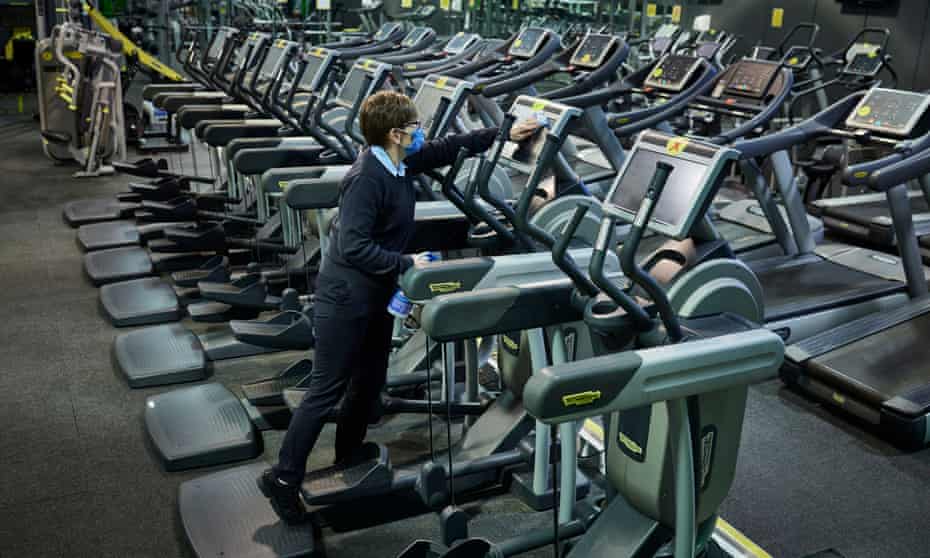 Person cleaning machines inside at a gym
