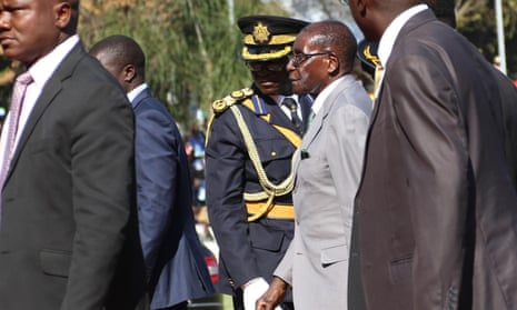 Zimbabwean president Robert Mugabe surrounded by bodyguards.