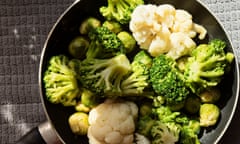 A frying pan with broccoli and cauliflower in natural sunlight