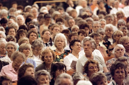 Crowd of women sat down in a venue.