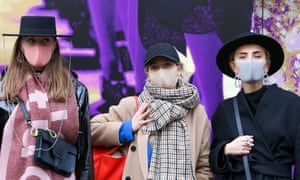 Women in face masks during London fashion week in February. In June, there will be no venue to attend.