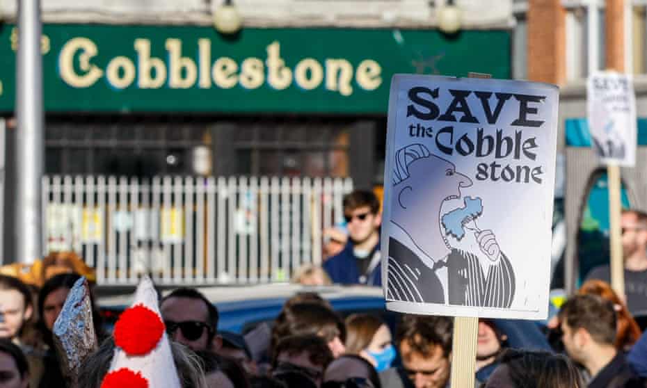 People protest against plans to turn The Cobblestone  pub and Irish music school into a hotel.
