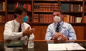 A grab from a video made available by official account of the president of Brazil, Jair Bolsonaro, which shows Bolsonaro (right), and the minister of health, Luiz Henrique Mandetta