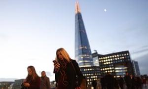 City workers walking across London Bridge.