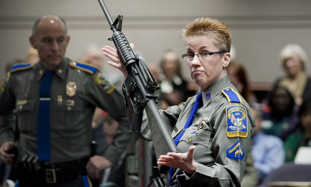 In 2013, Barbara J Mattson, of the Connecticut state police, holds up a Bushmaster AR-15 rifle, the same make and model of gun used in the Sandy Hook School shooting.