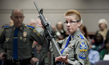 A Connecticut detective holds up a Bushmaster AR-15 rifle, the same make and model of gun used by Adam Lanza in the Sandy Hook school shooting.