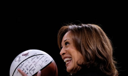 Woman smiles and holds signed basketball