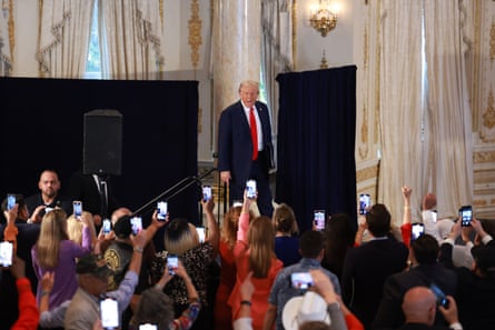 a man in front of people holding phones