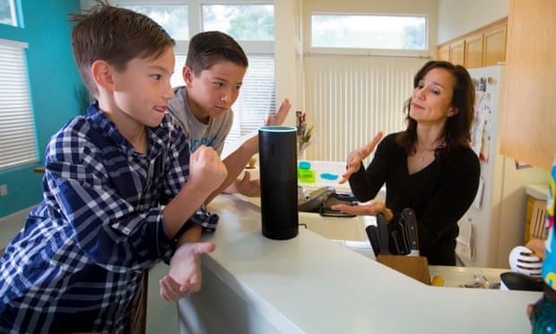 Amazon Alexa smart speaker in kitchen with children and mother