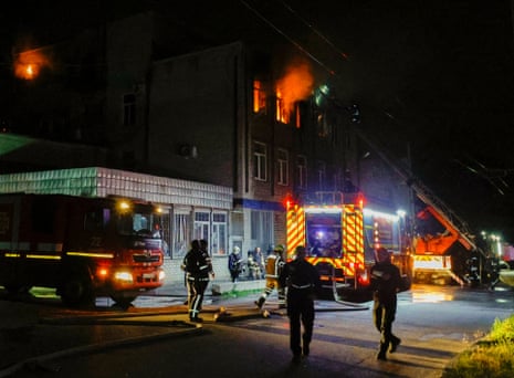 Rescuers work at the site of a drone strike in Kharkiv, northeastern Ukraine.
