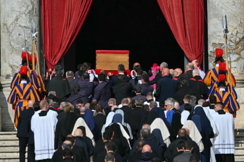 Pallbearers, next to Swiss Guards, carry the coffin of the late Pope Francis as it is transported from the chapel of Santa Marta to St Peter's Basilica.