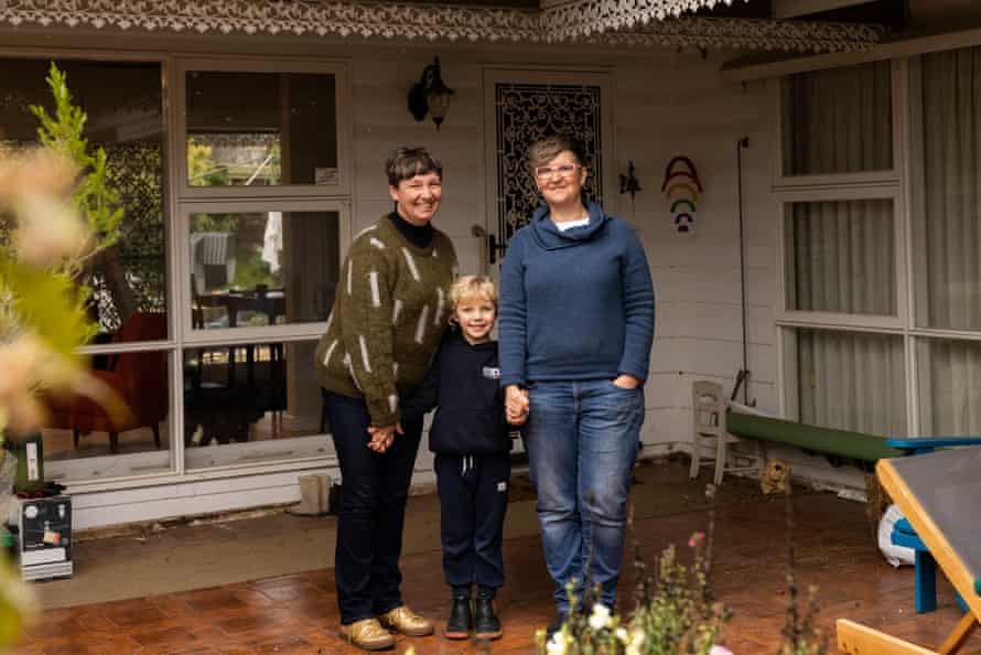 Jen Rae and Sally Beattie with their daughter, Vivi Rae, standing in front of the front door of their Castlemaine home
