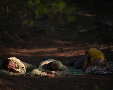 three firefighters lying down