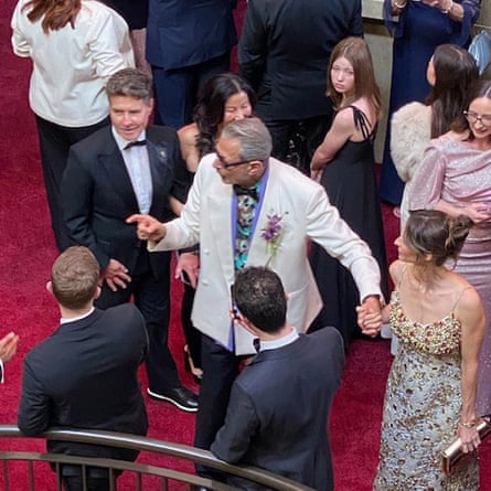 Jeff Goldblum gesticulating in a white jacket at the Oscars