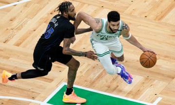 Celtics forward Jayson Tatum (0) drives past Mavericks forward Derrick Jones Jr during Game 1 of the NBA finals on Thursday in Boston. 