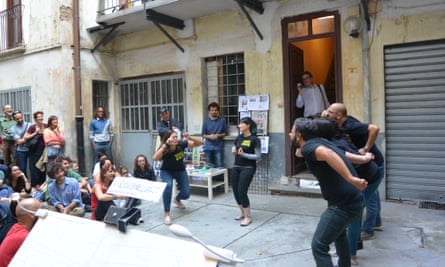 A theatre troupe perform in the courtyard.