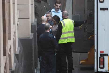Erin Patterson is escorted into the courthouse