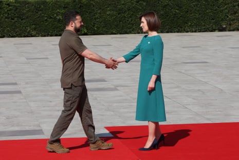 Volodymyr Zelenskiy shakes hands with Maia Sandu at a welcome ceremony at Mimi Castle in Bulboaca, Moldova.