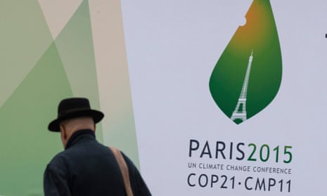 A passerby walks in front of posters for the forthcoming COP 21 World Climate Summit in Paris, France