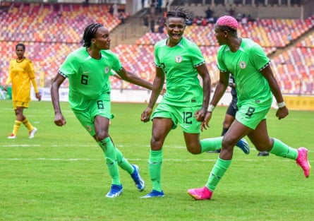 Nigeria women’s footballers celebrate a goal.