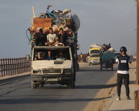Palestinians in a van loaded with personal possessions