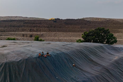 Children play on top of a capped section of the Bantar Gebang landfill