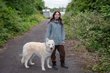 Hazel with dog in lane with caravans in background