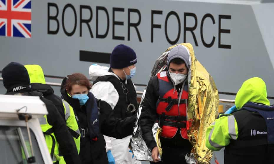 Border Force officers accompany rescued migrants in Dover, Kent